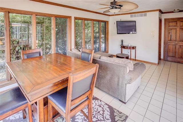 tiled dining area featuring ornamental molding and ceiling fan