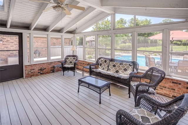 sunroom with vaulted ceiling with beams and ceiling fan