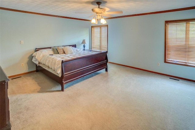 carpeted bedroom featuring ceiling fan and ornamental molding