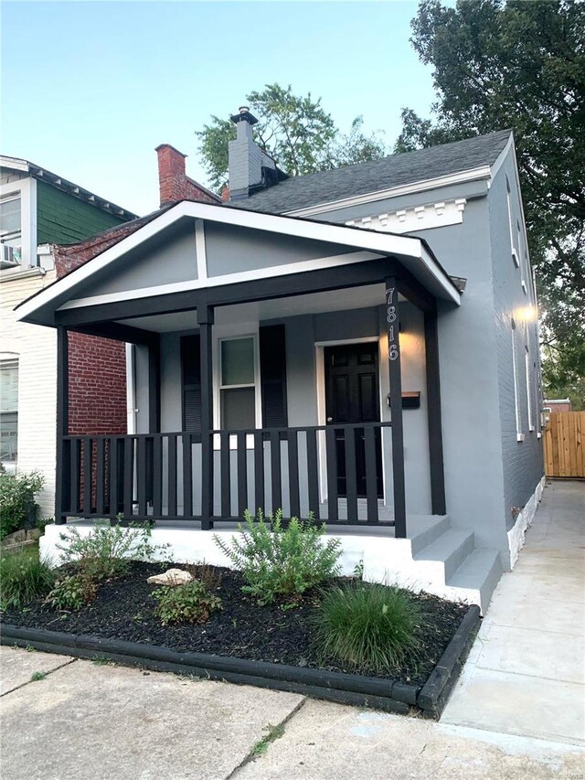 view of side of home featuring a porch