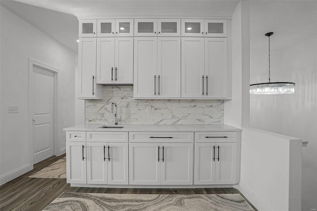 kitchen featuring pendant lighting, white cabinetry, sink, and dark wood-type flooring