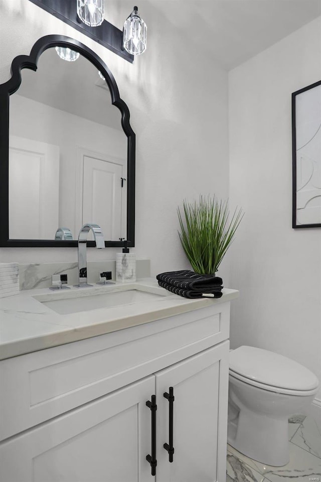 bathroom with vanity and toilet