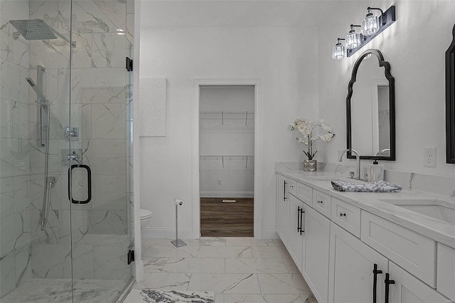 bathroom with vanity, toilet, and a shower with shower door