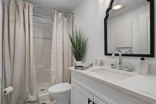 bathroom featuring toilet, vanity, and a shower with shower curtain