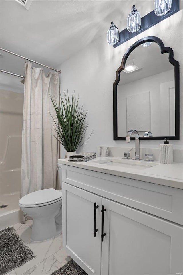 bathroom featuring toilet, vanity, and walk in shower