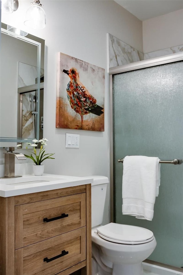 bathroom with vanity, toilet, and walk in shower