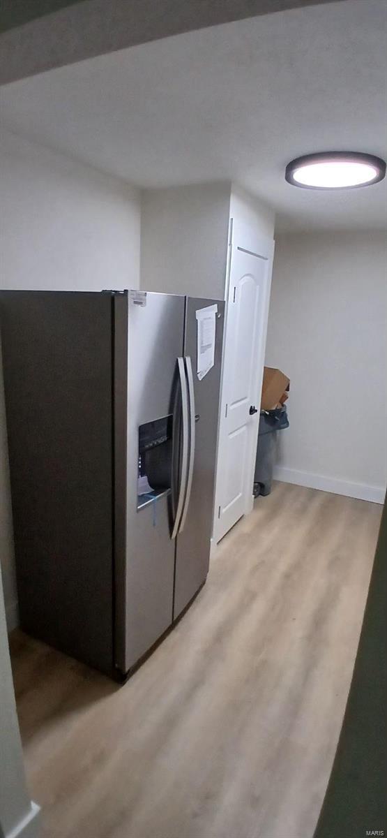 clothes washing area with hardwood / wood-style floors