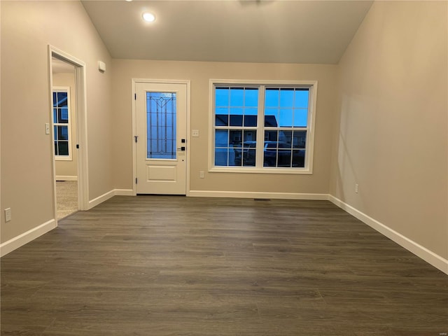 entryway with vaulted ceiling and dark hardwood / wood-style flooring