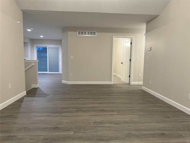 unfurnished room with dark wood-type flooring