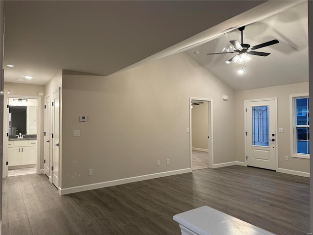 entrance foyer featuring dark wood-type flooring, vaulted ceiling, and ceiling fan