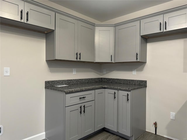 kitchen featuring gray cabinetry and dark hardwood / wood-style floors