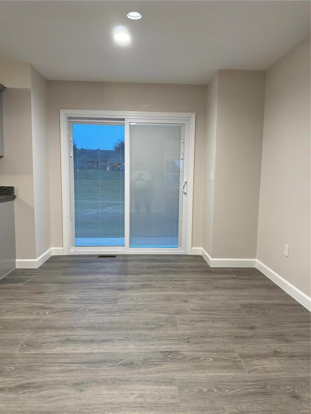 spare room with dark hardwood / wood-style floors