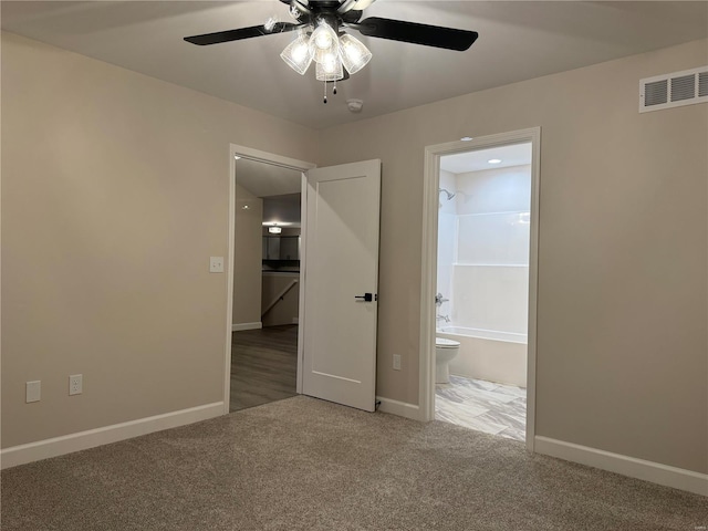 carpeted spare room featuring ceiling fan