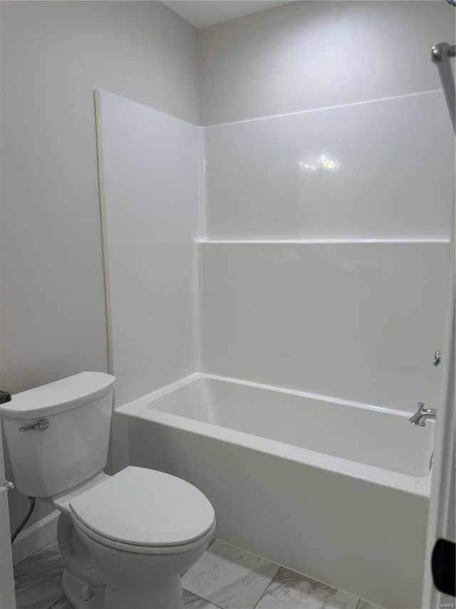 bathroom featuring shower / washtub combination and toilet