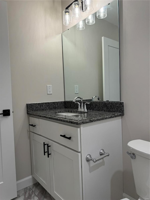 bathroom featuring vanity and toilet