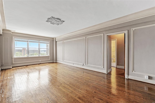 interior space featuring ornamental molding and dark hardwood / wood-style floors