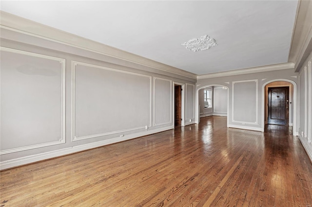 unfurnished room featuring crown molding and hardwood / wood-style flooring