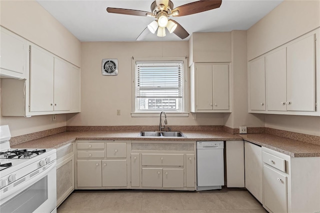 kitchen with sink, white appliances, white cabinets, and ceiling fan