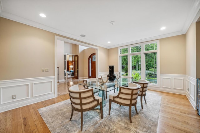 dining area featuring ornamental molding and light hardwood / wood-style floors