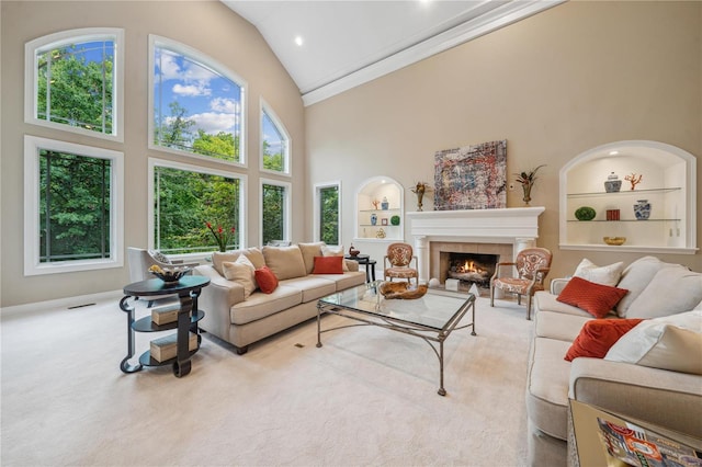 living room featuring light colored carpet, a fireplace, built in features, and high vaulted ceiling