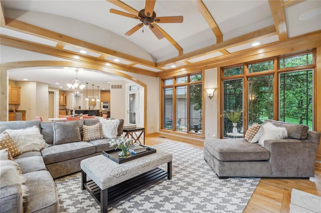 living room featuring vaulted ceiling with beams, ceiling fan with notable chandelier, and light hardwood / wood-style flooring