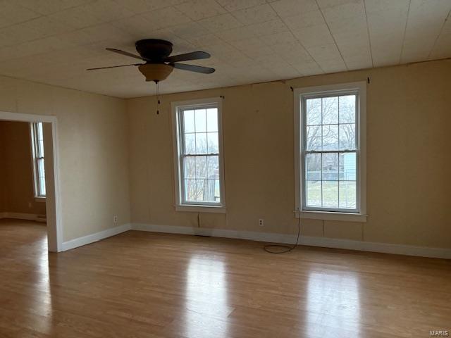 empty room featuring ceiling fan and light hardwood / wood-style flooring