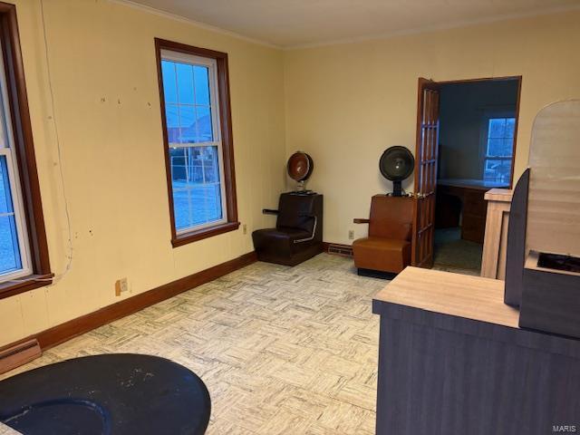 sitting room featuring crown molding and light parquet floors