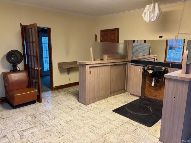 kitchen with kitchen peninsula and ornamental molding