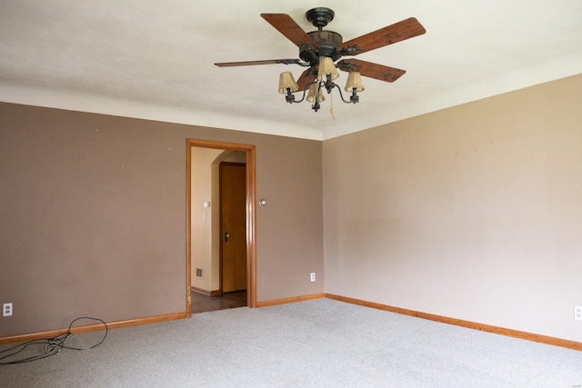 spare room featuring carpet and ceiling fan