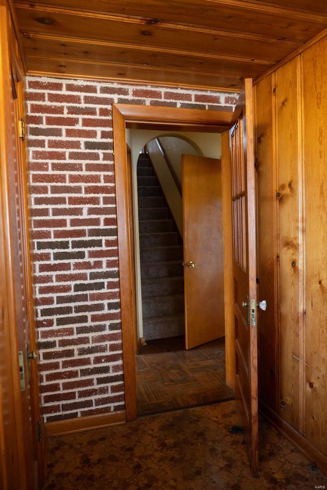 hall featuring wooden walls