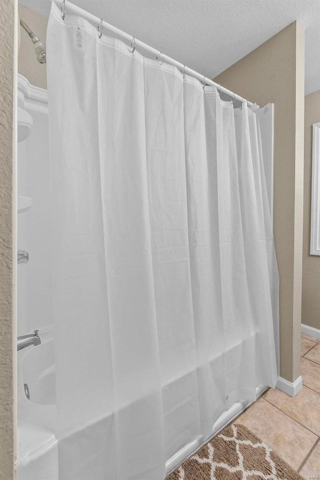 bathroom featuring tile patterned flooring and a textured ceiling