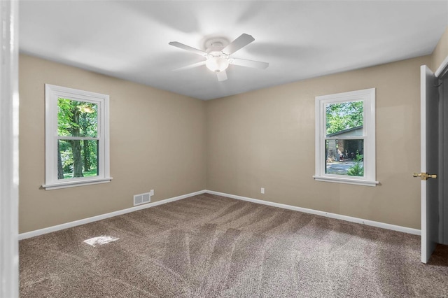 carpeted spare room with ceiling fan