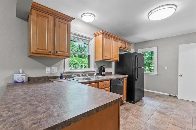 kitchen with sink, black appliances, a healthy amount of sunlight, and light tile patterned floors