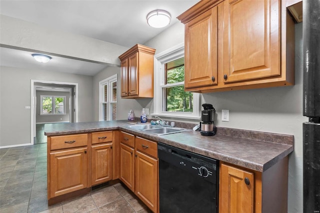 kitchen featuring black dishwasher, sink, kitchen peninsula, and dark tile patterned flooring