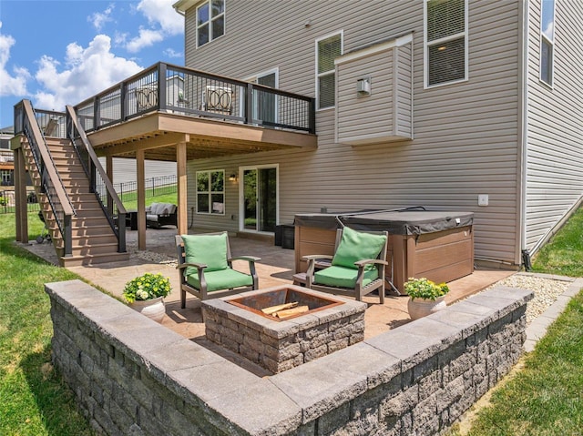 view of patio with a fire pit, a hot tub, and a wooden deck