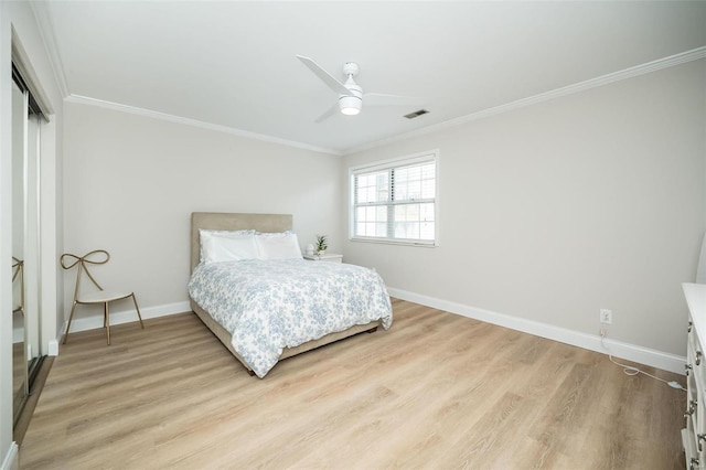 bedroom with crown molding, light hardwood / wood-style flooring, and ceiling fan