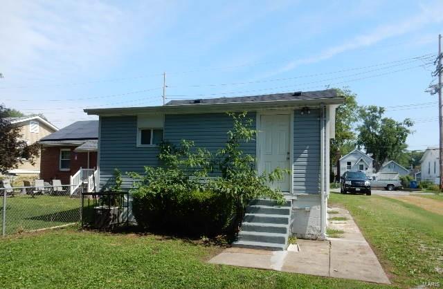 back of house with a yard