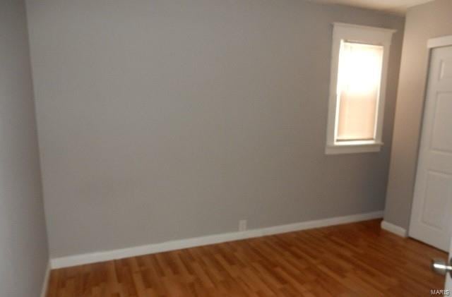 spare room with wood-type flooring