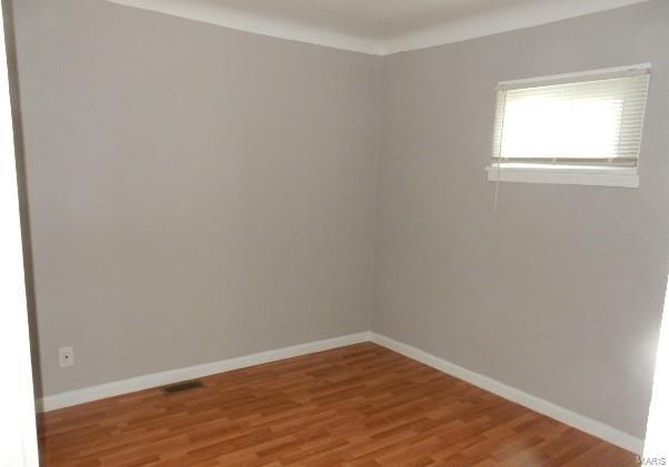 spare room with hardwood / wood-style flooring