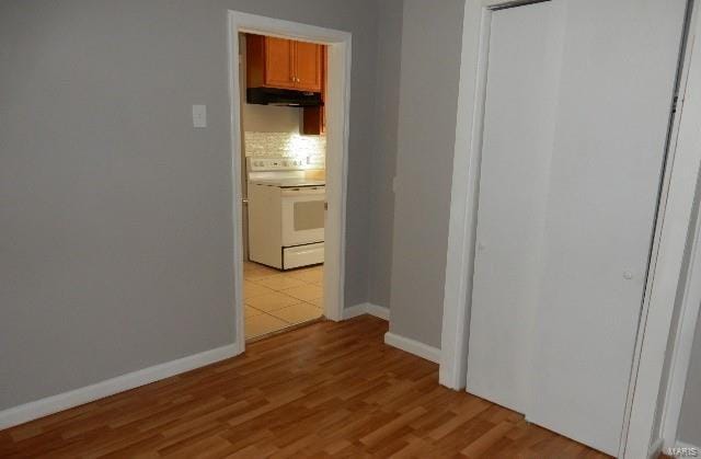 corridor with light hardwood / wood-style floors