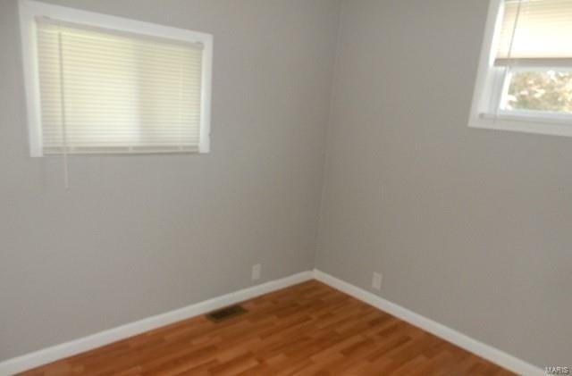 spare room featuring hardwood / wood-style flooring