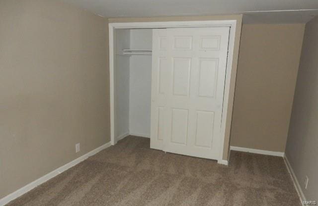 unfurnished bedroom featuring a closet and carpet flooring