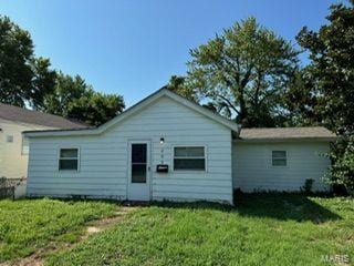 back of property featuring a lawn