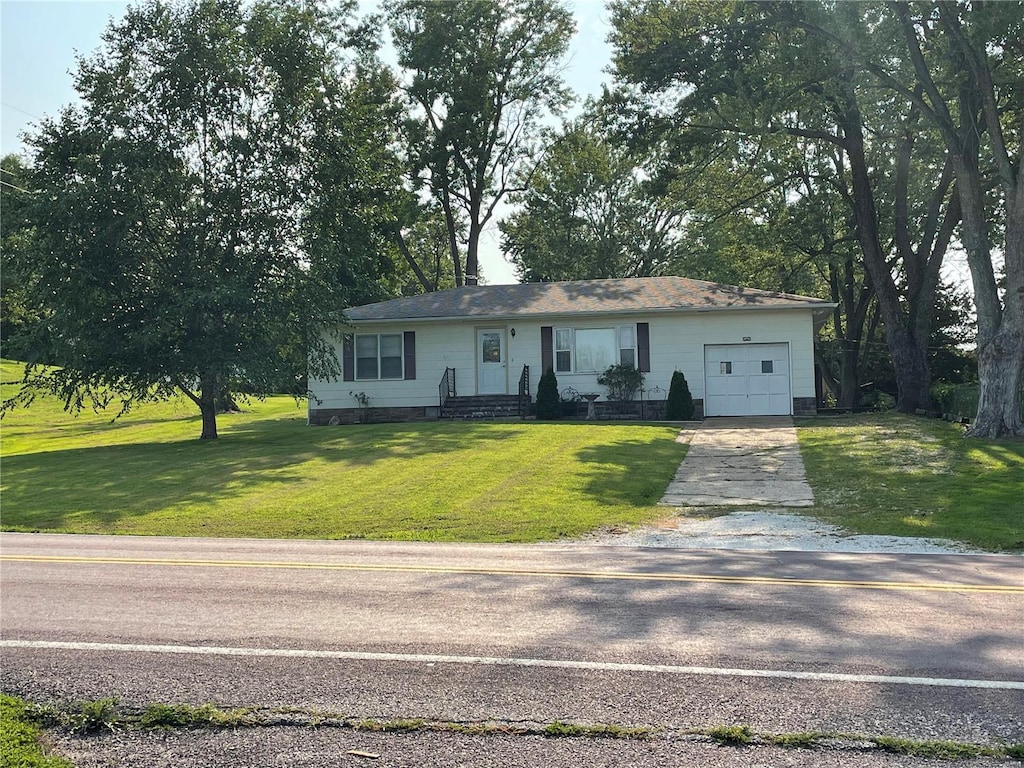 view of front of home featuring a garage and a front lawn