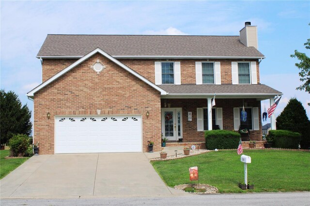 view of front of property with a garage and a front yard