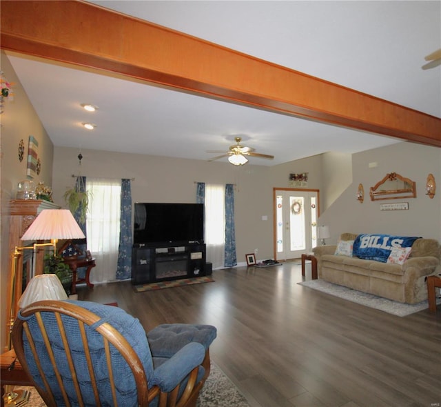 living room featuring plenty of natural light, dark wood-type flooring, ceiling fan, and lofted ceiling with beams