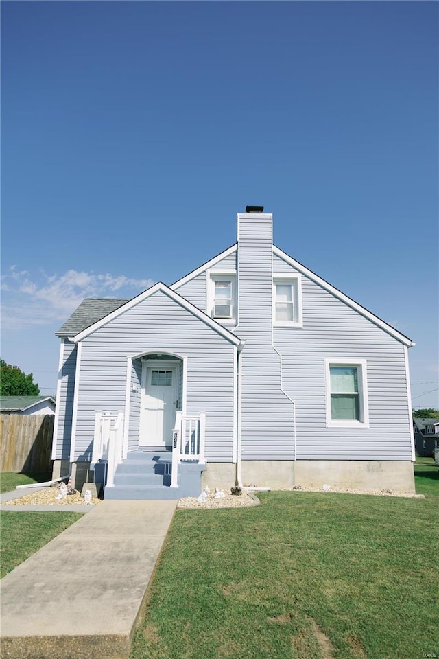 back of property featuring a lawn