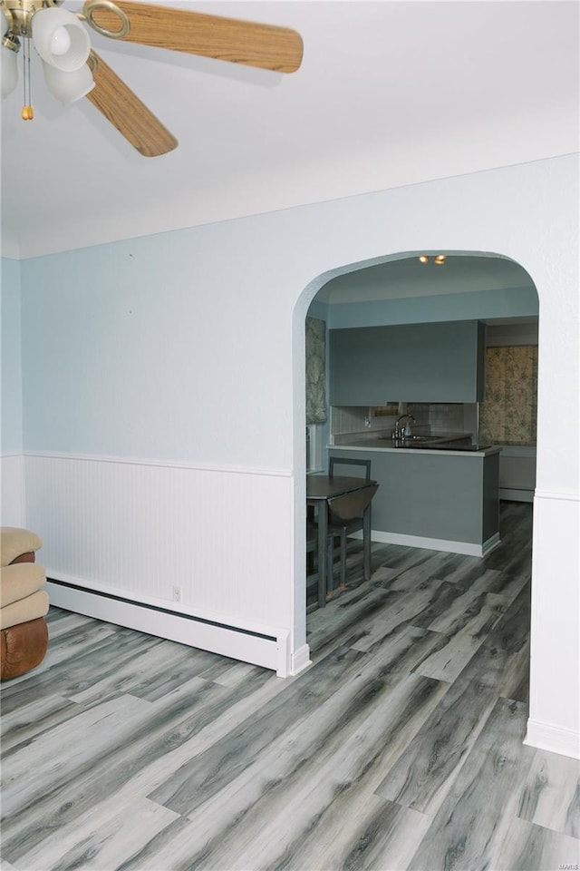 corridor featuring hardwood / wood-style floors, sink, and a baseboard radiator