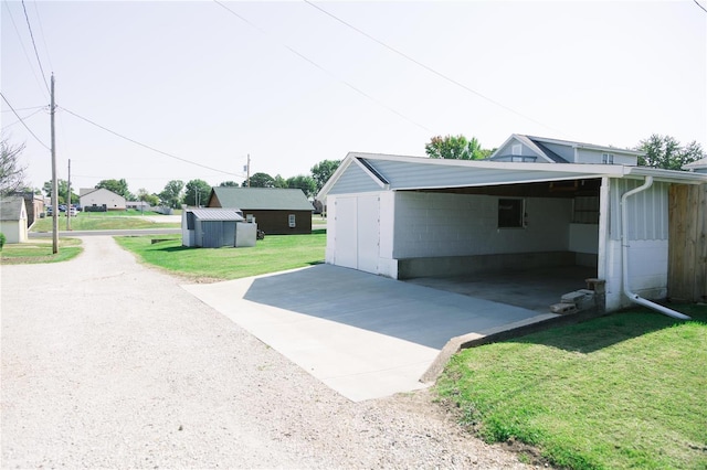 garage with a yard and a carport