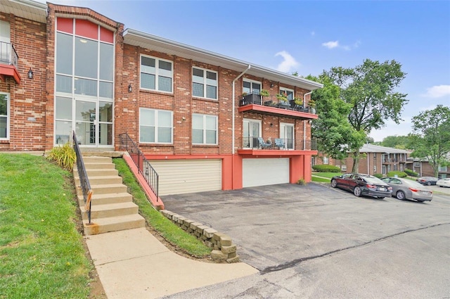 view of front of home with a balcony and a garage